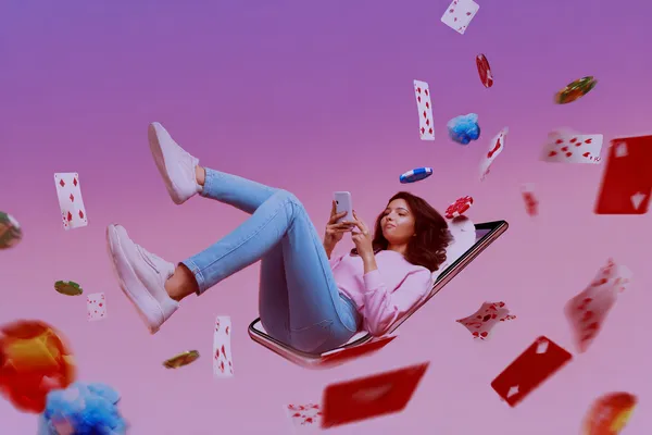 A young woman relaxing with her phone while dynamic casino elements float around her, illustrating the smooth mobile experience offered by the LUCK789 app.