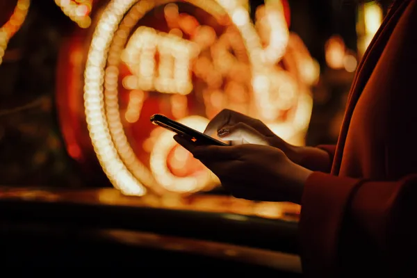 A person using their device against a moody casino-themed background, illustrating the smooth re-entry process at LUCK789.